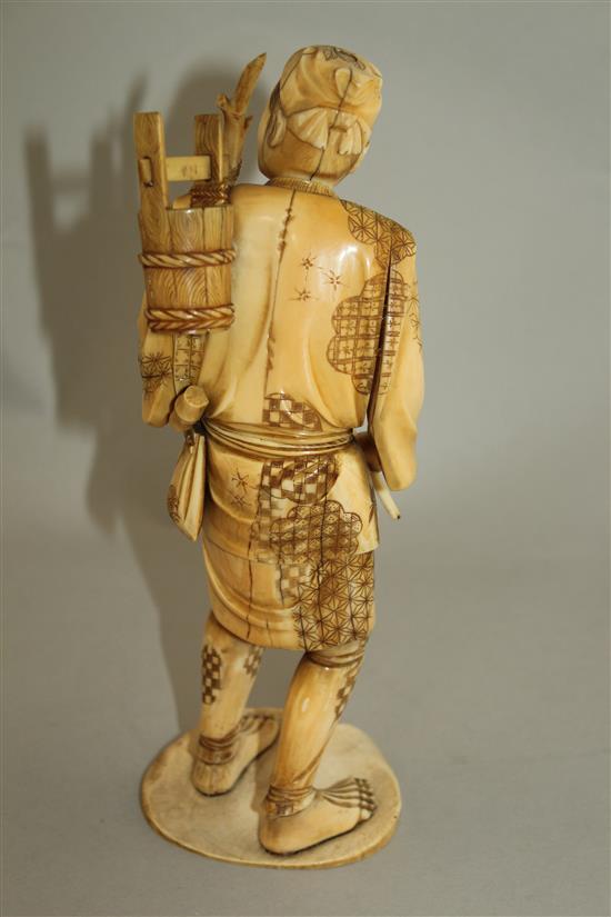 A Japanese sectional ivory figure of a woodsman, early 20th century, 24.5cm